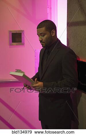Stock Photo - African American bouncer working at nightclub. Fotosearch