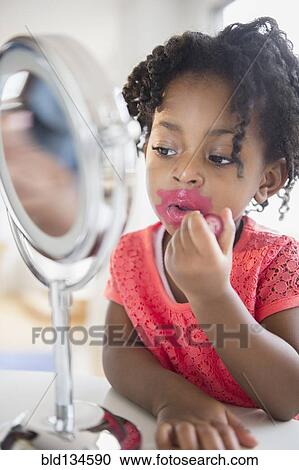 African American girl applying makeup View Large Photo Image Stock Image - African American girl applying makeup. Fotosearch