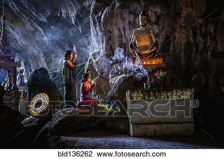 Asian girls lighting incense in temple View Large Photo Image Stock Image - Asian girls lighting incense in temple. Fotosearch