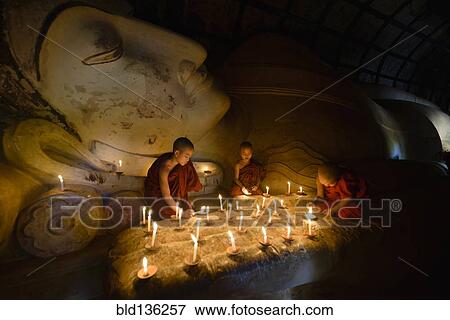 Asian monks lighting candles in temple View Large Photo Image Stock Photo - Asian monks lighting candles in temple. Fotosearch