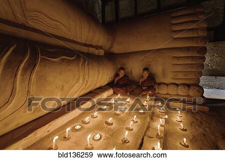 Asian monks lighting candles in temple View Large Photo Image Stock Photo - Asian monks lighting candles in temple. Fotosearch