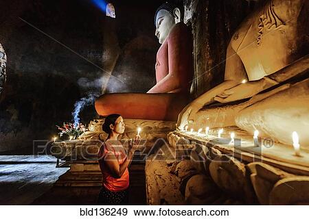 Asian woman lighting candle in temple View Large Photo Image Stock Photo - Asian woman lighting candle in temple. Fotosearch