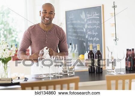 Black bartender smiling in restaurant View Large Photo Image Stock Image - Black bartender smiling in restaurant. Fotosearch
