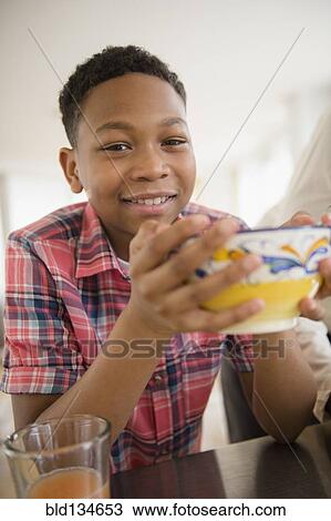 Black boy eating breakfast in kitchen View Large Photo Image Stock Image - Black boy eating breakfast in kitchen. Fotosearch
