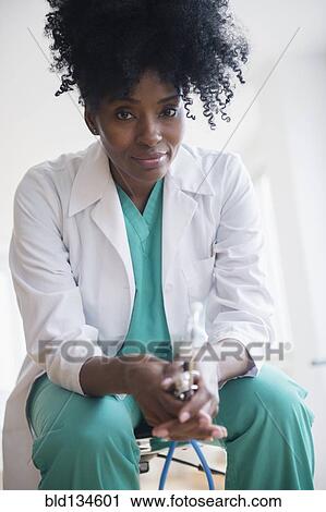 Black doctor holding stethoscope View Large Photo Image Stock Image - Black doctor holding stethoscope. Fotosearch