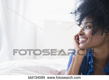 Black woman smiling on bed View Large Photo Image Stock Photography - Black woman smiling on bed. Fotosearch