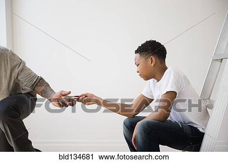Boy giving father pliers View Large Photo Image Stock Image - Boy giving father pliers. Fotosearch