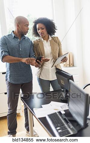 Stock Photography - Business people talking in office. Fotosearch