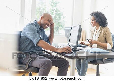 Stock Image - Business people working in office. Fotosearch