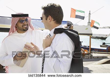 Picture - Businessmen talking on city street. Fotosearch