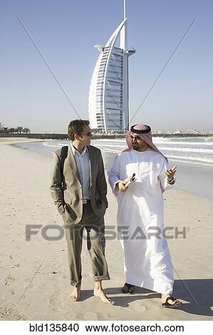 Businessmen walking on beach, Dubai, United Arab Emirates View Large Photo Image Stock Image - Businessmen walking on beach, Dubai, United Arab Emirates. Fotosearch