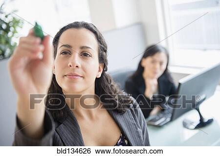 Stock Photograph - Businesswomen working in office. Fotosearch