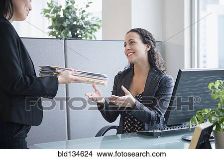 Businesswomen working together in office View Large Photo Image Picture - Businesswomen working together in office. Fotosearch