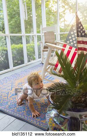 Caucasian baby crawling on porch View Large Photo Image Stock Image - Caucasian baby crawling on porch. Fotosearch