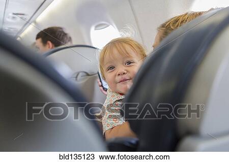 Caucasian baby laughing on airplane View Large Photo Image Stock Image - Caucasian baby laughing on airplane. Fotosearch