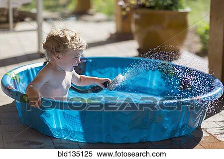 Caucasian baby playing with hose in wading pool View Large Photo Image Stock Photography - Caucasian baby playing with hose in wading pool. Fotosearch