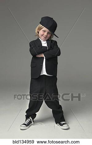 Caucasian boy posing in oversized suit View Large Photo Image Stock Photo - Caucasian boy posing in oversized suit. Fotosearch