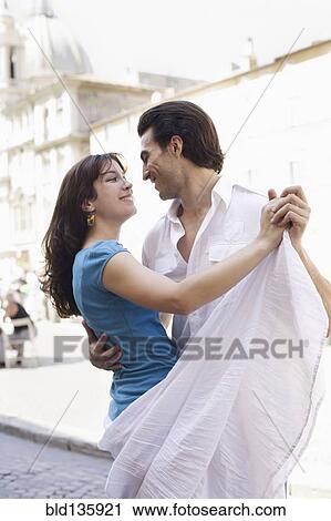 Caucasian couple dancing on city street View Large Photo Image Stock Image - Caucasian couple dancing on city street. Fotosearch