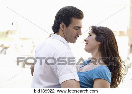 Stock Image - Caucasian couple dancing on city street. Fotosearch