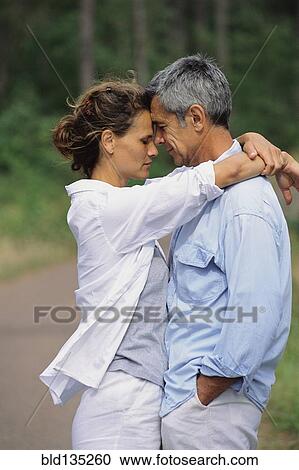 Caucasian couple hugging in park View Large Photo Image Stock Image - Caucasian couple hugging in park. Fotosearch