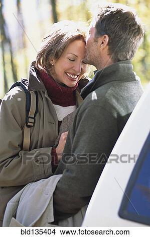 Caucasian couple kissing by car View Large Photo Image Picture - Caucasian couple kissing by car. Fotosearch
