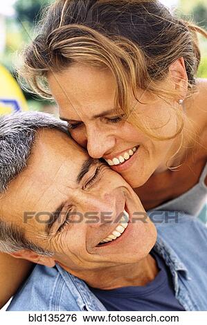 Caucasian couple smiling outdoors View Large Photo Image Stock Photograph - Caucasian couple smiling outdoors. Fotosearch