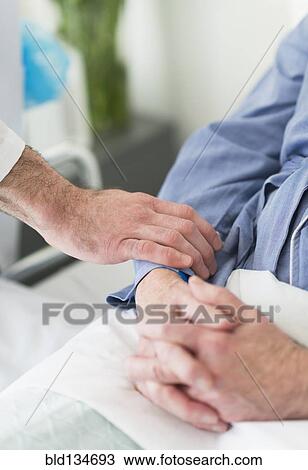 Caucasian doctor reassuring patient in hospital View Large Photo Image Stock Image - Caucasian doctor reassuring patient in hospital. Fotosearch