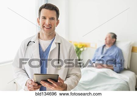 Stock Photograph - Caucasian doctor using digital tablet in hospital. Fotosearch