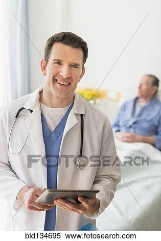 Caucasian doctor using digital tablet in hospital View Large Photo Image Stock Photography - Caucasian doctor using digital tablet in hospital. Fotosearch