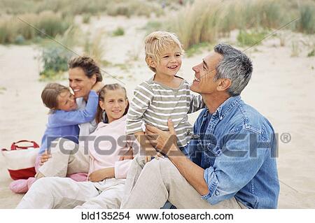 Caucasian family having picnic on beach View Large Photo Image Picture - Caucasian family having picnic on beach. Fotosearch