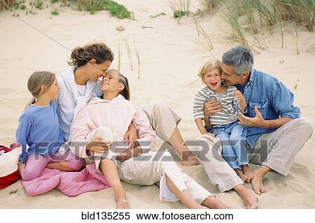 Caucasian family having picnic on beach View Large Photo Image Stock Photography - Caucasian family having picnic on beach. Fotosearch