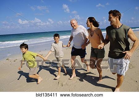Caucasian family holding hands on beach View Large Photo Image Stock Image - Caucasian family holding hands on beach. Fotosearch