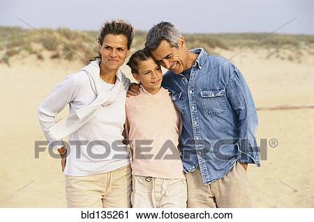 Caucasian family hugging on beach View Large Photo Image Stock Image - Caucasian family hugging on beach. Fotosearch