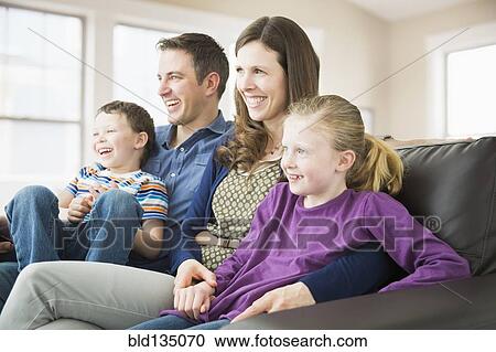 Caucasian family relaxing on sofa View Large Photo Image Stock Image - Caucasian family relaxing on sofa. Fotosearch