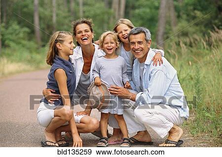 Stock Photo - Caucasian family smiling in park. Fotosearch
