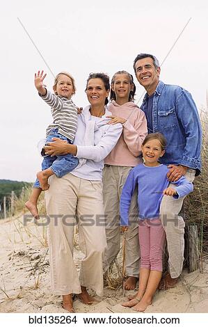 Picture - Caucasian family smiling on beach. Fotosearch