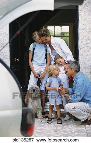 Stock Photo - Caucasian family standing in doorway. Fotosearch