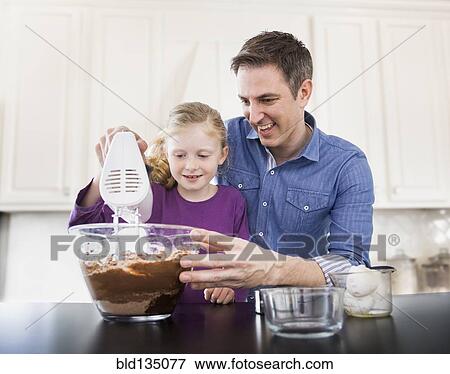 Caucasian father and daughter baking together View Large Photo Image Stock Photo - Caucasian father and daughter baking together. Fotosearch