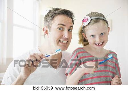 Caucasian father and daughter brushing their teeth View Large Photo Image Stock Photo - Caucasian father and daughter brushing their teeth. Fotosearch
