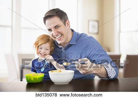 Caucasian father and daughter eating breakfast together View Large Photo Image Stock Photo - Caucasian father and daughter eating breakfast together. Fotosearch