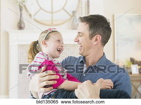 Stock Photography - Caucasian father and daughter playing together. Fotosearch