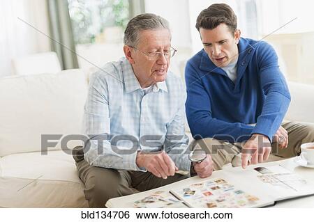 Caucasian father and son examining stamp collection View Large Photo Image Stock Photograph - Caucasian father and son examining stamp collection. Fotosearch