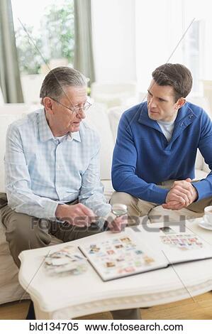 Caucasian father and son examining stamp collection View Large Photo Image Stock Photography - Caucasian father and son examining stamp collection. Fotosearch
