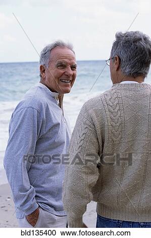 Caucasian father and son walking on beach View Large Photo Image Stock Image - Caucasian father and son walking on beach. Fotosearch