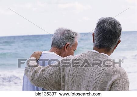 Caucasian father and son walking on beach View Large Photo Image Stock Photo - Caucasian father and son walking on beach. Fotosearch