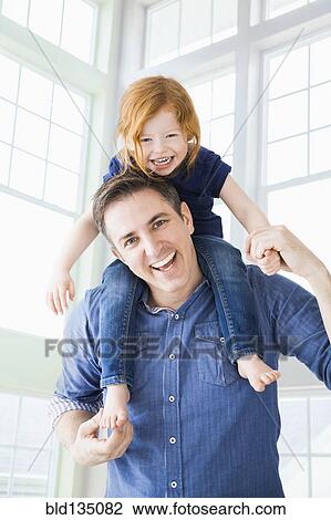 Caucasian father carrying daughter on shoulders View Large Photo Image Stock Image - Caucasian father carrying daughter on shoulders. Fotosearch