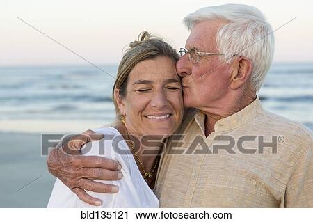 Caucasian father kissing daughter on beach View Large Photo Image Stock Image - Caucasian father kissing daughter on beach. Fotosearch