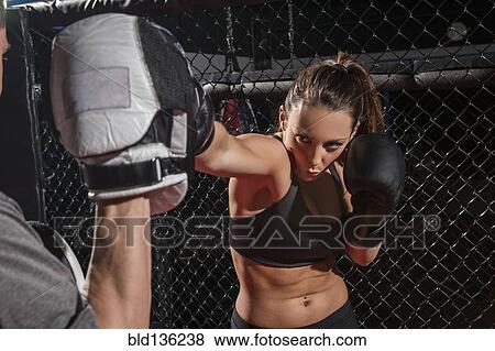 Caucasian fighter working with trainer in gym View Large Photo Image Stock Photo - Caucasian fighter working with trainer in gym. Fotosearch