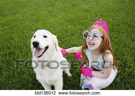 Stock Image - Caucasian girl playing dress up in park. Fotosearch