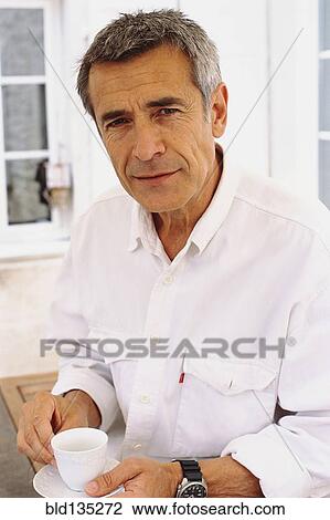 Caucasian man drinking coffee outdoors View Large Photo Image Stock Image - Caucasian man drinking coffee outdoors. Fotosearch